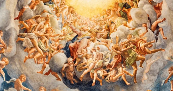 A dome fresco crowded with swirling figures and angels among golden clouds